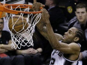 San Antonio Spurs forward Kawhi Leonard (2) dunks against the Miami Heat during the first half in Game 5 of the NBA basketball finals on Sunday, June 15, 2014, in San Antonio. (AP Photo/Tony Gutierrez)