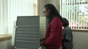 stock-footage-voting-young-male-and-female-african-american-in-voting-booths