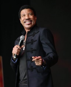 In this June 28, 2015 file photo, Lionel Richie performs on the Pyramid stage at Glastonbury music festival on Worthy Farm, Glastonbury, England. Richie has been named the MusiCares person of the year and will be honored by Pharrell Williams, Luke Bryan and Lady Antebellum next year prior to the Grammys. The Recording Academy on Tuesday, Aug. 18, named the four-time Grammy winner as the honoree of their annual MusiCares benefit gala, which will be held Feb. 13 in Los Angeles before the 58th annual Grammy Awards. (Photo by Joel Ryan/Invision/AP)
