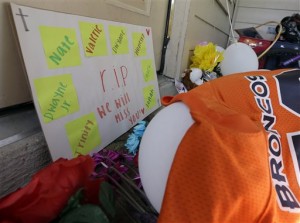 A sign sits against the door Monday, Aug. 10, 2015, as part of the condolences left outside the home where eight people were shot over the weekend in Houston. David Conley, who has a violent criminal history, entered the Houston home through an unlocked window and fatally shot a woman he'd previously dated, her husband and six children, including a boy believed to be his own son, authorities said. He is charged with capital murder in the deaths (AP Photo/David J. Phillip)
