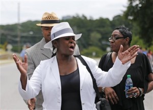 Leolah Brown talks with media members outside the church hosting a funeral service for her brother Bobby Brown's daughter, Bobbi Kristina Brown, Saturday, Aug. 1, 2015, in Alpharetta, Ga. She said she was angry because Pat Houston was speaking at the funeral. Pat Houston is the sister-in-law and former manager for the late Whitney Houston. Bobbi Kristina, the only child of Whitney Houston and R&B singer Bobby Brown, died in hospice care July 26, about six months after she was found face-down and unresponsive in a bathtub in her suburban Atlanta townhome. (AP Photo/John Bazemore)