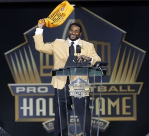 Former NFL player Jerome Bettis waves a Terrible Towel at the conclusion of his speech during inductions at the Pro Football Hall of Fame on Saturday, Aug. 8, 2015, in Canton, Ohio. (AP Photo/Tom E. Puskar)