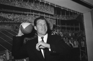 FILE - In this April 2, 1962 file photo, New York Giants halfback Frank Gifford cocks his passing arm as he stands in front of photo mural of the Polo Grounds at the offices of the New York Giants in New Yorks Coliseum.  In a statement released by NBC News on Sunday, Aug. 9, 2015, his family said Gifford died suddenly at his Connecticut home of natural causes that morning. (AP Photo, File)
