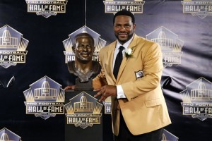 Former NFL player Jerome Bettis poses with his bust  during an induction ceremony at the Pro Football Hall of Fame Saturday, Aug. 8, 2015, in Canton, Ohio.  (AP Photo/Gene J. Puskar)