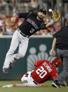 Washington Nationals' Ian Desmond (20) safely steals second base as Colorado Rockies shortstop Daniel Descalso (3) jumps to field the throw during the seventh inning of a baseball game at Nationals Park, Saturday, Aug. 8, 2015, in Washington. The Nationals won 6-1. (AP Photo/Alex Brandon)