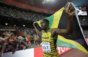 Jamaica's Usain Bolt celebrates after winning the gold medal in the men's 100m ahead of United States' at the World Athletics Championships at the Bird's Nest stadium in Beijing, Sunday, Aug. 23, 2015. (AP Photo/Lee Jin-man)