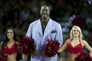In this Oct. 6, 2013, file photo, former Philadelphia's 76ers' Darryl Dawkins, center, receives a tribute before a match against Bilbao Basket, during an NBA Global basketball game in Bilbao, northern Spain. Darryl Dawkins, whose backboard-shattering dunks earned him the moniker "Chocolate Thunder" and helped pave the way for breakaway rims, has died. He was 58. The Lehigh County, Pennsylvania coroner's office said Dawkins died Thursday morning, Aug. 27, 2015,  at a hospital. (AP Photo/Alvaro Barrientos, File)