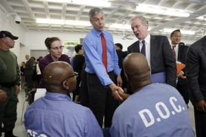 Education Secretary Arne Duncan, center, speaks with inmates Alphonso Coates, bottom right, and Kenard Johnson, both participants in the Goucher College Prison Education Partnership at Maryland Correctional Institution-Jessup, Friday, July 31, 2015, in Jessup, Md. After a roundtable discussion at the prison, the Education Department announced Friday that it would conduct a limited pilot program to give prisoners access to the Pell grants, allowing them to take college courses behind bars. (AP Photo/Patrick Semansky)