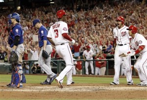 Washington Nationals' Michael Taylor (3) celebrates after four runs scored on his bases-loaded single, with an error by New York Mets center fielder Yoenis Cespedes, as Mets starting pitcher Matt Harvey (33) walks back to the mound during the sixth inning of a baseball game at Nationals Park, Tuesday, Sept. 8, 2015, in Washington. (AP Photo/Alex Brandon)