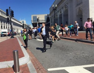 In this image provided by Ursula Lauriston, people move rapidly out of Union Station, Friday, Sept. 11, 2015, in Washington.  A security guard shot a man who stabbed a woman inside Union Station on Friday, the anniversary of the September 11 attacks, District of Columbia police said. The guard saw the man stabbing the woman and chased him, police spokesman Gwendolyn Crump said in a statement. The man turned and pointed the knife at the security guard, who opened fire, and the man was shot, she said. (Ursula Lauriston via AP)