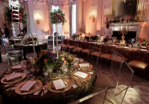 FILE - In this Jan. 19, 2011, file photo, workers prepare the State Dining Room of the White House in Washington, for a State Dinner in honor of  China's President Hu Jintao. China will get its second state dinner under President Barack Obama when its leader, Xi Jinping, arrives at the White House on Friday. That leaves an entity viewed all over the world as the ultimate in entertaining perfection grappling with a basic question: How to make this dinner better than the last one? A state dinner is the glitzy end to a state visit, a high honor usually reserved for long-standing and close U.S. allies. That makes the double honor especially unique for China, as the two nations continue to differ on several issues including human rights and cyber security. (AP Photo/Carolyn Kaster, File)