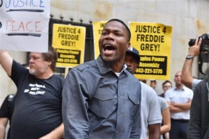 Protesters gather outside Baltimore Circuit Court, as the first court hearing was set to begin in the case of six police officers criminally charged in the death of Freddie Gray, on Wednesday, Sept. 2, 2015 in Baltimore.  Six police officers face charges that range from second-degree assault, a misdemeanor, to second-degree "depraved-heart" murder.   (Kim Hairston/The Baltimore Sun via AP)  WASHINGTON EXAMINER OUT; MANDATORY CREDIT  (