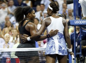 Serena Williams, left, greets Venus Williams after winning their quarterfinal match at the U.S. Open tennis tournament, Tuesday, Sept. 8, 2015, in New York. (AP Photo/Julio Cortez)