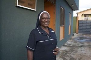 In this photo taken Saturday Aug. 22, 2015. Patricia Ebegbulem, a catholic nun, stands outside the door of Bakhita Villa, a shelter she runs for trafficking survivors in Lagos, Nigeria. Nigeria, Africa's most populous country with 170 million people, is a regional hub for human trafficking, and more assistance is needed to help those who escape the exploitation to find a stable place back in Nigeria, say experts who work with survivors. Nigeria tops the list of non-EU citizens registered as trafficking victims, according to the European Commission's 2015 Eurostat report. (AP Photo/Caelainn Hogan)