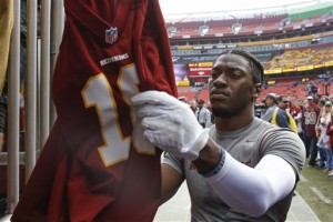 Washington Redskins quarterback Robert Griffin III (10) signs autographs before an NFL football game against the Tampa Bay Buccaneers in Landover, Md., Sunday, Oct. 25, 2015. (AP Photo/Patrick Semansky)