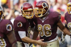 Washington Redskins quarterback Kirk Cousins (8) congratulates tight end Jordan Reed (86) after Reed scored the tying touchdown during the second half of an NFL football game in Landover, Md., Sunday, Oct. 25, 2015. The Washington Redskins defeated the Tampa Bay Buccaneers 31-30. (AP Photo/Patrick Semansky)