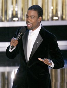 In this Feb. 27, 2005 file photo, Chris Rock hosts the 77th Academy Awards telecast in Los Angeles. Rock will return to host the Oscars for a second time. The shows producers say the prolific comedian-filmmaker will be at the helm for the 88th Academy Awards next February 28. (AP Photo/Mark J. Terrill, File)