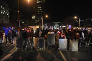 Protesters march during a demonstration for 17-year-old Laquan McDonald, Tuesday, Nov. 24, 2015, in Chicago. Chicago police Officer Jason Van Dyke, who shot McDonald 16 times last year, was charged with first-degree murder Tuesday, hours before the city released a video of the killing.  (AP Photo/Paul Beaty)