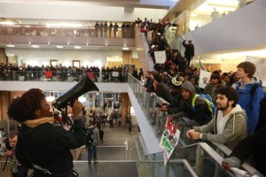 Palca Shibale, left,  and members of minority student groups lead a rally through Odegaard Library at the University of Washington in Seattle on Thursday, Nov. 12, 2015. The rally is to show solidarity with the black community and organization Concerned Student 1950 at the University of Missouri, Columbia.  (Bettina Hansen/The Seattle Times via AP)    OUTS: SEATTLE OUT, USA TODAY OUT, MAGAZINES OUT, ONLINE OUT, TELEVISION OUT, SALES OUT. MANDATORY CREDIT TO:  Bettina Hansen / THE SEATTLE TIMES.