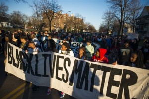 Protesters marched down Plymouth Ave. N to the Minneapolis 4th Precinct.  Neighbors and community members gathered at the scene where a man was shot and wounded by a Minneapolis Police officer early Sunday, Nov. 15, 2015. The shooting outraged some community members and prompted a protest by the group Black Lives Matter Minneapolis, after some witnesses said the man was handcuffed when he was shot. Police have said their preliminary investigation shows the man was not handcuffed, but the investigation is ongoing. (Mark Vancleave/Star Tribune via AP)