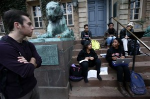 Students gather at the entrance of Nassau Hall at Princeton University, Wednesday, Nov. 18, 2015, in Princeton, N.J. The students, from a group called the Black Justice League, demand that the school remove the name of former school president and U.S. President Woodrow Wilson from programs and buildings over what they said was his racist legacy. (AP Photo/Julio Cortez)