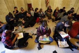 Students gather inside Nassau Hall during a sit-in, Thursday, Nov. 19, 2015, in Princeton, N.J. The protesters from a group called the Black Justice League, who staged a sit-in inside university President Christopher Eisgruber's office on Tuesday, demand the school remove the name of former school president and U.S. President Woodrow Wilson from programs and buildings over what they said was his racist legacy. (AP Photo/Julio Cortez)
