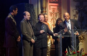 In this Nov. 8, 2001 file photo, members of "Sly and the Family Stone," Larry Graham, from left, Greg Errico, Jerry Martini, Cynthia Robinson, and Sly Stone's sister and brother, Rosie and Freddie Stewart, accept a Pioneer Award at the Apollo Theatre, in New York. Robinson, a trumpeter and vocalist for Sly and the Family Stone, has died at age 71. Her death was confirmed by Jerry Martini, her longtime friend and fellow horn player in the band. He says he was among those with her when she died of cancer Nov. 23, 2015, at her sisters home in Carmichael, Calif.  (AP Photo/Louis Lanzano, File)