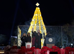 From left, actress Reese Witherspoon, Sasha Obama, first lady Michelle Obama's mother Marian Robinson, Malia Obama, President Barack Obama, and first lady Michelle Obama, react after they light the National Christmas Tree during the National Christmas Tree Lighting ceremony at the Ellipse in Washington, Thursday, Dec. 3, 2015. (AP Photo/Carolyn Kaster)