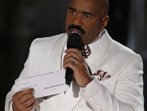 Steve Harvey holds up the card showing the winners after he incorrectly announced Miss Colombia Ariadna Gutierrez at the winner at the Miss Universe pageant Sunday, Dec. 20, 2015, in Las Vegas. According to the pageant, a misreading led the announcer to read Miss Colombia  as the winner before they took it away and gave it to Miss Philippines Pia Alonzo Wurtzbach.(AP Photo/John Locher)