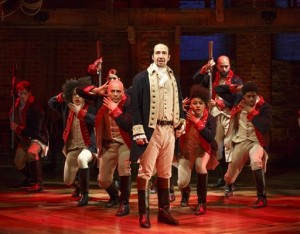 This image released by The Public Theater shows Lin-Manuel Miranda, foreground, with the cast during a performance of "Hamilton," in New York. Another milestone has fallen thanks to the Broadway musical Hamilton - this time on Twitter. The microblogging website said Monday, Dec. 21, 2015, that there have been over 1 million tweets about the hip-hop show featuring the life of nation's first treasury secretary. (Joan Marcus/The Public Theater via AP)