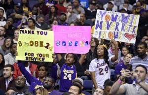 Fans hold up signs supporting Los Angeles Lakers forward Kobe Bryant during the first half of an NBA basketball game against the Washington Wizards, Wednesday, Dec. 2, 2015, in Washington. (AP Photo/Nick Wass)