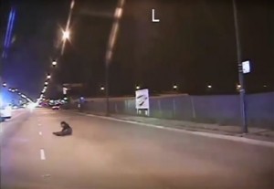 In this Oct. 20, 2014 frame from dash-cam video provided by Chicago Police Department, Laquan McDonald falls to the ground after being shot by officer Jason Van Dyke in Chicago. Van Dyke, who shot McDonald 16 times, was charged with first-degree murder Tuesday, Nov. 24, 2015. (Chicago Police Department via AP)