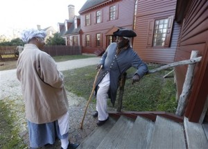 In this photo taken on Tuesday, Dec. 15, 2015, historical interpreters Robert Watson Jr., talks with a fellow interpreter, Janice Canaday, left, at the Randolph house in the restored area of Colonial Williamsburg in Williamsburg, Va. Despite a growing and continuing emphasis on African-American history, Colonial Williamsburg has struggled to attract more black visitors to the historic village where interpreters stroll the streets attired in bonnets and tricorn hats. Its a hard sell when human enslavement is a part of the story youre trying to tell.   (AP Photo/Steve Helber)