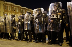 FILE - In this April 28, 2015 file photo, police stand in formation as a curfew approache in Baltimore, a day after unrest that occurred following Freddie Gray's funeral. On the campaign trail, among candidates of both parties, the idea of locking up drug criminals for life is a lot less popular than it was a generation ago. The 2016 presidential race has accelerated an evolution away from the traditional tough-on-crime candidate. A Republican Party thats long taken a law-and-order stance finds itself desperate to improve its standing among minority voters while Democratic candidates are also being drawn into national conversations on policing, drug crimes and prison costs. (AP Photo/Patrick Semansky, File)