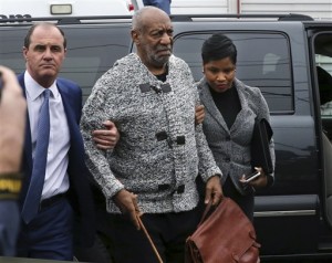 Actor and comedian Bill Cosby is helped as he arrives for a court appearance, Wednesday, Dec. 30, 2015, in Elkins Park, Pa. Cosby was arrested and charged with drugging and sexually assaulting a woman at his home in January 2004. (AP Photo/Mel Evans)