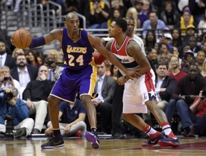 Los Angeles Lakers forward Kobe Bryant (24) dribbles against Washington Wizards guard Bradley Beal, right, during the second half of an NBA basketball game, Wednesday, Dec. 2, 2015, in Washington. The Lakers won 108-104. (AP Photo/Nick Wass)