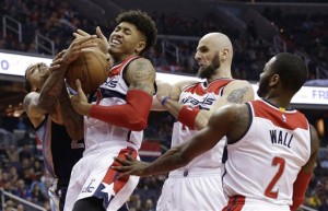 Memphis Grizzlies forward Matt Barnes, left, and Washington Wizards forward Kelly Oubre Jr. (12) fight for a rebound as Washington Wizards center Marcin Gortat (13) and guard John Wall (2) move in during the first half of an NBA basketball game, Wednesday, Dec. 23, 2015, in Washington. (AP Photo/Carolyn Kaster)