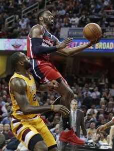 Washington Wizards' John Wall (2) drives to the basket against Cleveland Cavaliers' LeBron James (23) in the first half of an NBA basketball game Tuesday, Dec. 1, 2015, in Cleveland. (AP Photo/Tony Dejak)