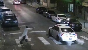 In this frame from a Thursday, Jan. 7, 2016 video provided by the Philadelphia Police Department, Edward Archer runs with a gun toward a police car driven by Officer Jesse Hartnett in Philadelphia. Archer, using a gun stolen from police, said he was acting in the name of Islam when he ambushed Hartnett sitting in his marked cruiser at an intersection, firing shots at point-blank range, authorities said. (Philadelphia Police Department via AP)