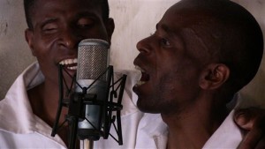 In this photo taken August 24, 2014 and supplied by the Zomba Prison Project, members of the Zomba Prison group record songs at the Zomba Prison, in southern Malawi. The gentle chorus of maximum security prisoners singing over guitar chords has earned Malawi its first Grammy nomination making history in the impoverished African nation. (Marilena Delli/Zomba Prison Project via AP)