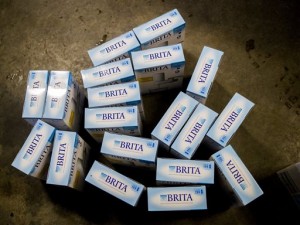 Brita water filters rest on the floor for pickup from Flint residents at a Flint fire station on Wednesday, Jan. 13, 2016 in Flint, as the first seven Michigan National Guard soldiers arrive, assigned by Gov. Rick Snyder on Tuesday to help distribute water and relieve residents in relation to the Flint water crisis. American Red Cross is already stationed and aiding citizens in this effort.Safe drinking water has not flowed from many Flint faucets for almost two years after the state-run city switched its source to the highly corrosive Flint River and failed to treat it properly to protect lead from leaching into it. (Jake May/The Flint Journal-MLive.com via AP)