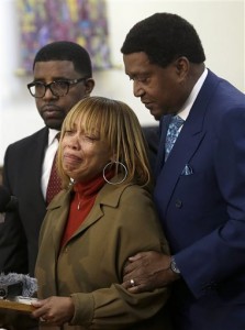 Attorney John Burris, right, comforts Gwendolyn Woods, the mother of Mario Woods, the man killed by San Francisco police after they say he appeared to raise an 8-inch knife and approach an officer, as she speaks at a news conference in San Francisco, Monday, Jan. 18, 2016. The family has asked the U.S. Department of Justice to investigate the officers who shot Woods on Dec. 2, 2015, and review the department's use of deadly force, stops, and detention and searches of African American and Latino citizens for possible civil rights violations. (AP Photo/Jeff Chiu)