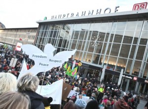 Demonstrators protest  against racism and sexism in the wake of the sexual assaults on New Year's Eve,  in front of the main station in Cologne, Germany,  Saturday Jan. 9,  2016. After the sexual assaults around Cologne's main station on New Year's Eve, various groups have called for demonstrations on Saturday.  (Oliver Berg/dpa via AP)