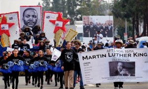 Participants march during the Martin Luther King Jr. parade in Los Angeles on Monday Jan. 18, 2016. The 31st annual Kingdom Day Parade honoring Martin Luther King Jr. was themed "Our Work Is Not Yet Done" (AP Photo/Richard Vogel)