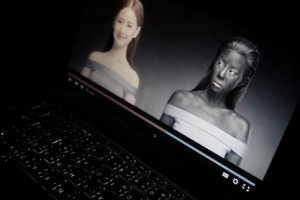 An online advertisement by Thai cosmetics company Seoul Secret showing Thai actress Cris Horwang, right, is displayed on a computer screen in Bangkok, Thailand, Friday, Jan. 8, 2016. The company has pulled a video in which the Thai movie star wears blackface and promotes a skin-whitener with the slogan: "You just need to be white to win." Seoul Secret issued a "heartfelt apology," saying in a statement it had had no intention to convey racist messages. (AP Photo/Charles Dharapak)