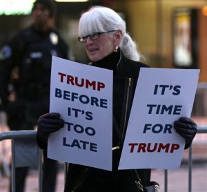 A supporter of Republican presidential candidate Donald Trump holds signs as she waits outside the Flynn Center of the Performing Arts prior to a Trump campaign stop in Burlington, Vt., Thursday, Jan. 7, 2016. (AP Photo/Charles Krupa)