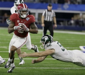 Alabama defensive back Cyrus Jones (5) eludes Michigan State long snapper Taybor Pepper (52) on his way to a 57-yard touchdown during the second half of the Cotton Bowl NCAA college football semifinal playoff game, Thursday, Dec. 31, 2015, in Arlington, Texas. (AP Photo/Tony Gutierrez)