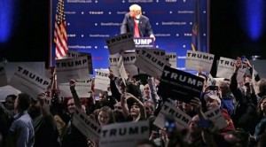 Supporters turn to show their support as a protestor interrupts an address by Republican presidential candidate Donald Trump during a campaign stop at the Flynn Center of the Performing Arts in Burlington, Vt., Thursday, Jan. 7, 2016. (AP Photo/Charles Krupa)