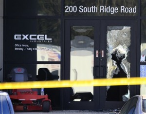 Shattered glass and bullet holes are seen at the front door of Excel Industries in Hesston, Kan., Friday, Feb. 26, 2016. Harvey County Sheriff T. Walton identified the gunman as Cedric Ford, who stormed into the factory where he worked and shot several people.  (AP Photo/Orlin Wagner)