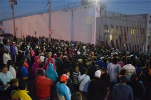 Relatives of inmates stand outside the Topo Chico prison, where a riot broke out around midnight, in Monterrey, Mexico, Thursday, Feb. 11, 2016. Dozens of inmates were killed and several injured in a brutal fight between two rival factions at a prison in northern Mexico on Thursday, the state governor said. (AP Photo/Emilio Vazquez)